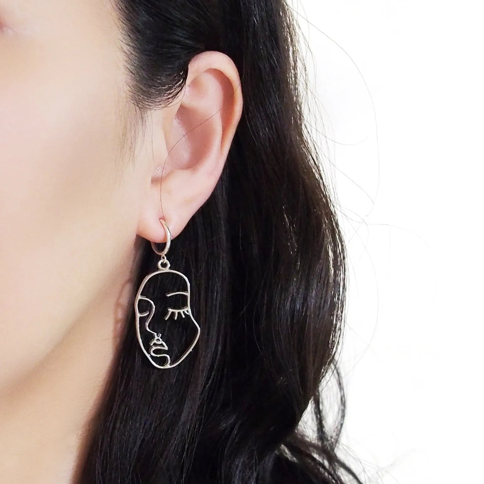 Silver human face clip on hoop earrings